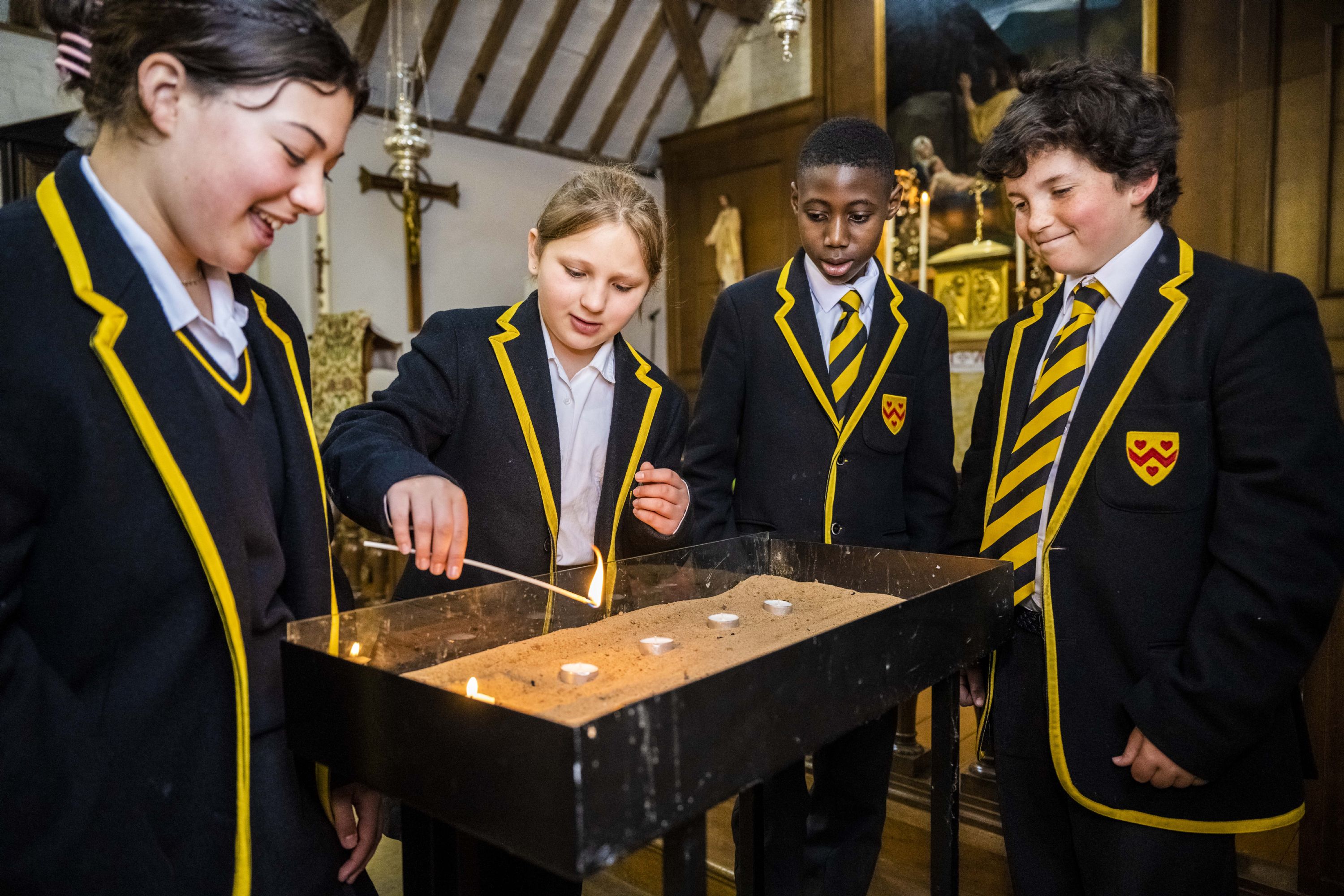 girl pupils lighting candles